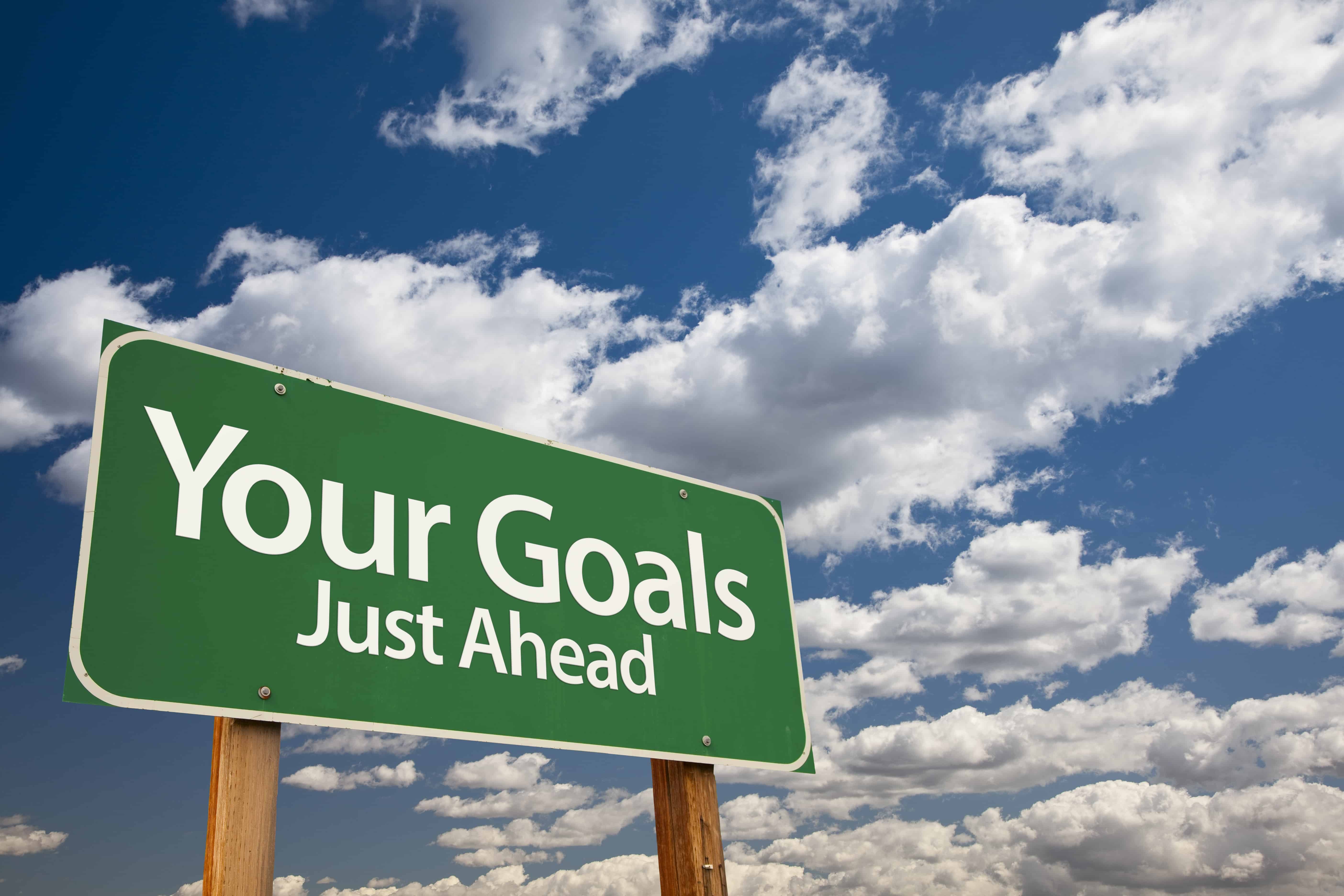 Your Goals Green Road Sign Over Dramatic Clouds and Sky.